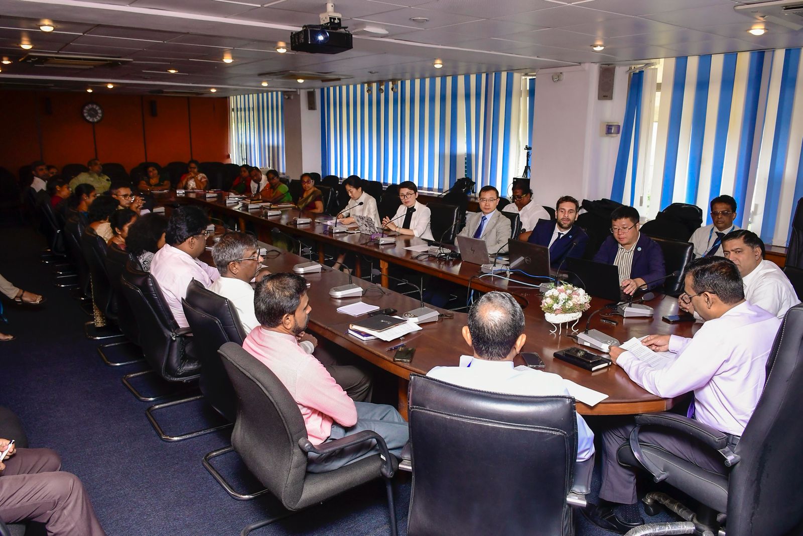 Government and international representatives discussing an aquaculture project